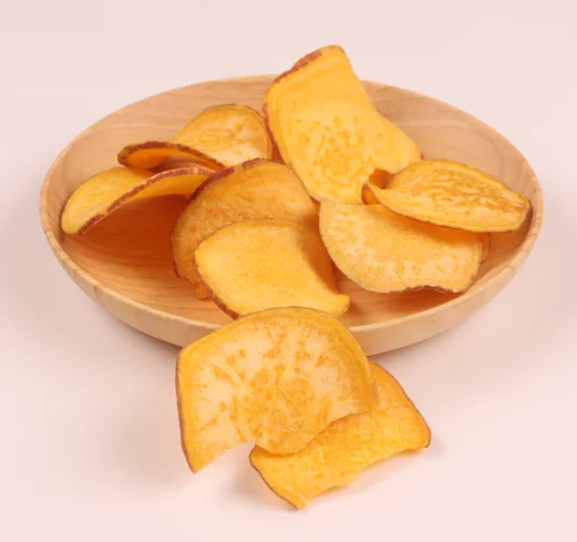 Vacuum-fried sweet potato chips on a wooden plate